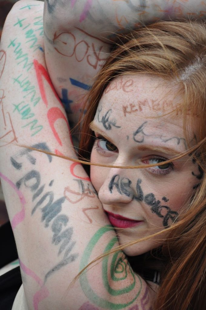 headshot of annika sheaff with writing on her face
